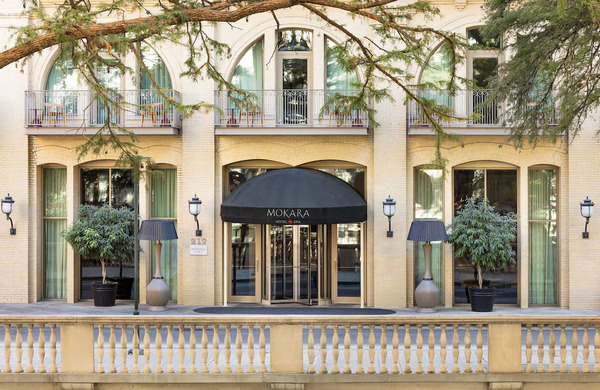 Exterior view of Mokara Hotel & Spa in San Antonio, featuring elegant luxury architecture, sophisticated design, and a prime location along the San Antonio River Walk.