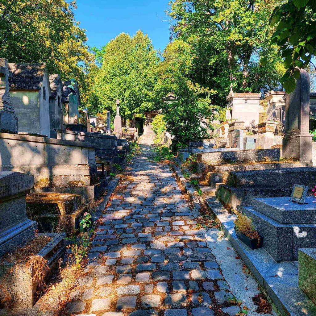 Spring greenery and historic tombs at Père Lachaise Cemetery in Paris