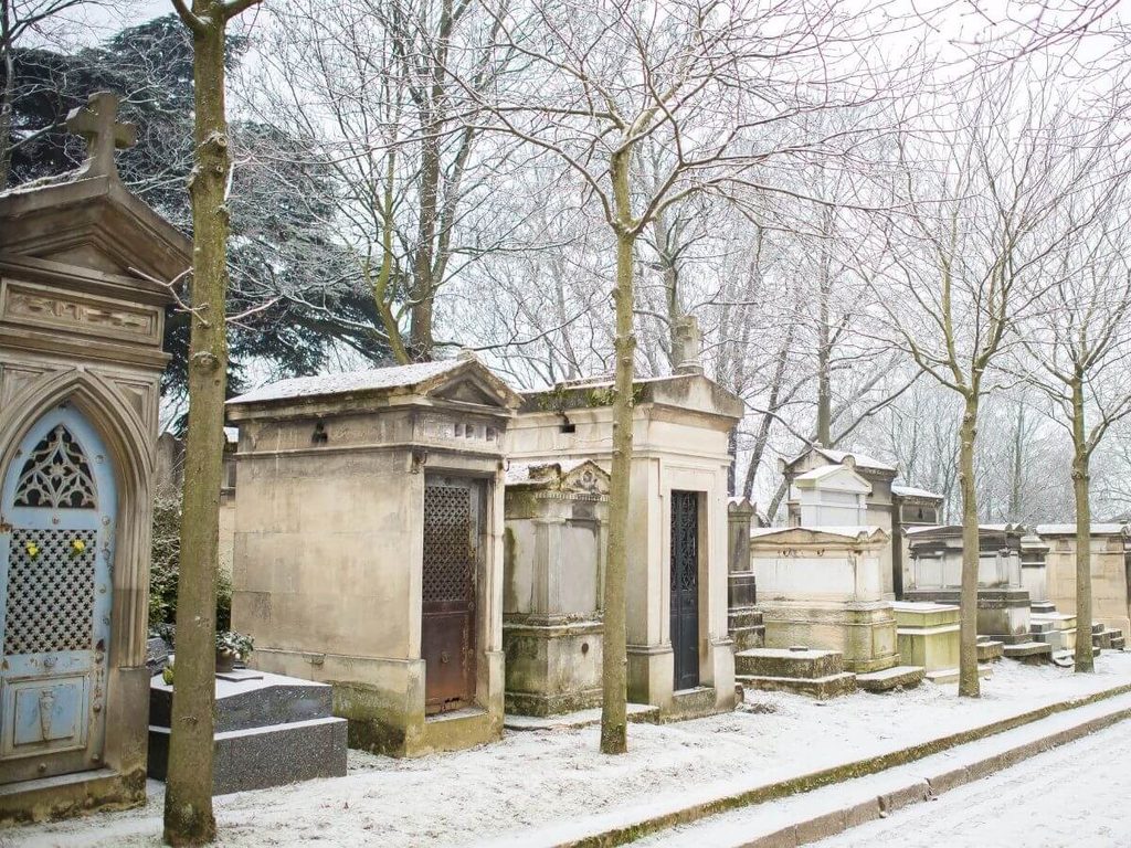Winter view of bare trees and historic tombs at Père Lachaise Cemetery