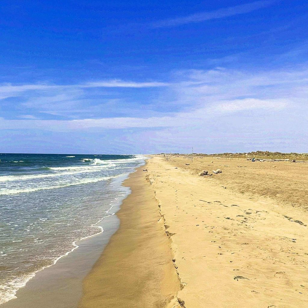 Wide sandy beach and dunes at Plage de Piémanson in the Camargue