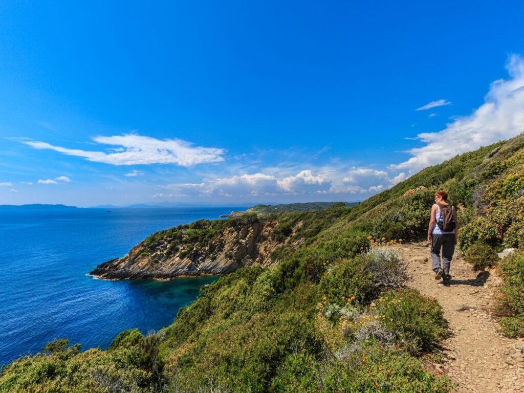 Hiker carrying a backpack along a Port-Cros trail