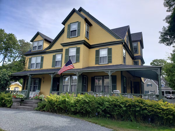 Sand Bar Cottage Inn in Bar Harbor, Maine, featuring charming coastal cottage-style architecture and a peaceful New England setting