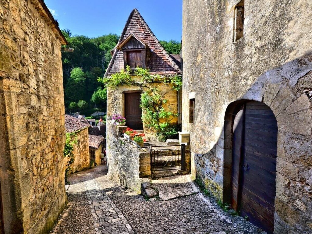 Narrow medieval street in Beynac-et-Cazenac lined with traditional stone houses