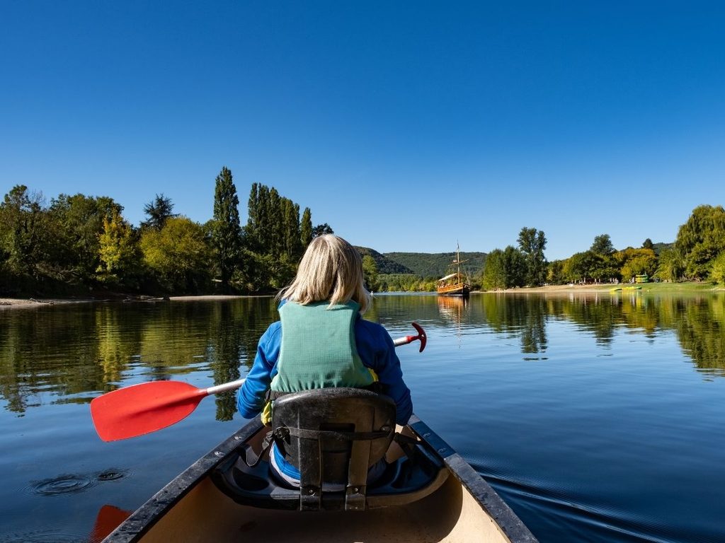 Canoeists paddling along the Dordogne River near Beynac-et-Cazenac