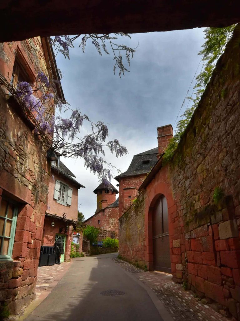 Wide view of Collonges-la-Rouge with red sandstone houses and historic towers