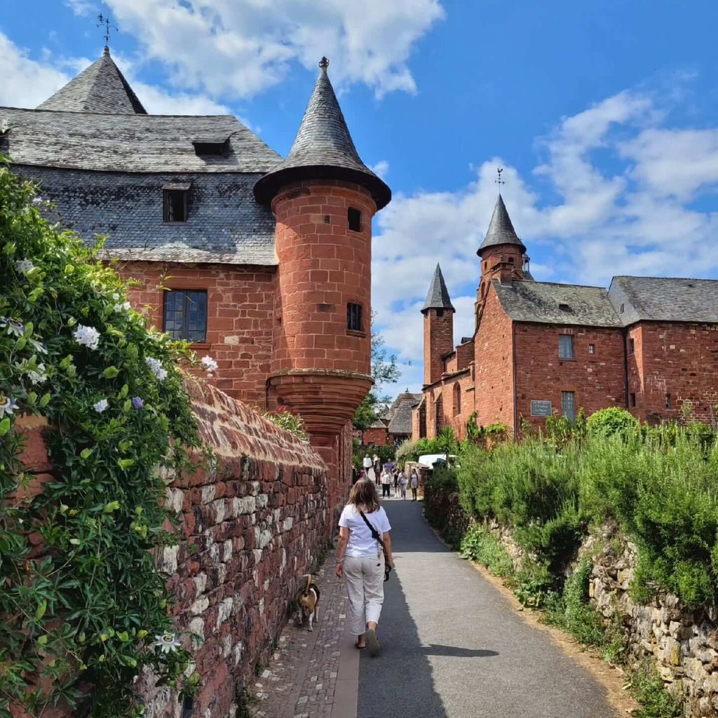 Summer visitors walking through Collonges-la-Rouge