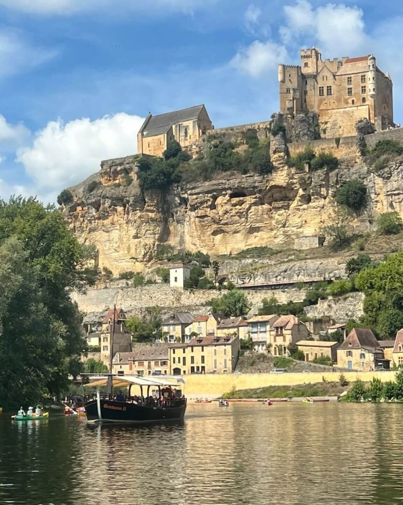 Traditional gabarre boat cruising along the Dordogne near Beynac