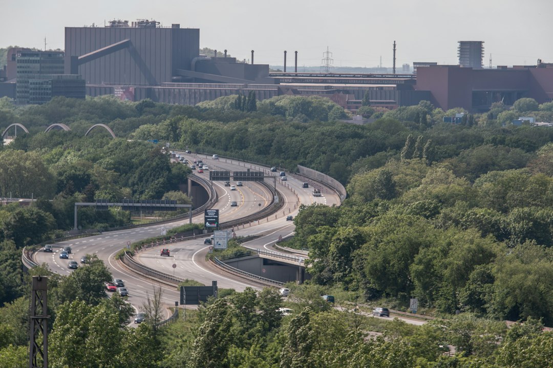A multi-lane German Autobahn stretching toward an overpass bridge