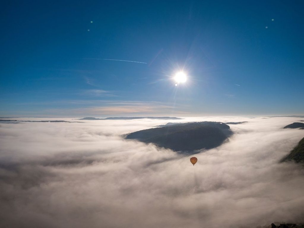 Hot air balloon flying above the Dordogne Valley near Beynac-et-Cazenac