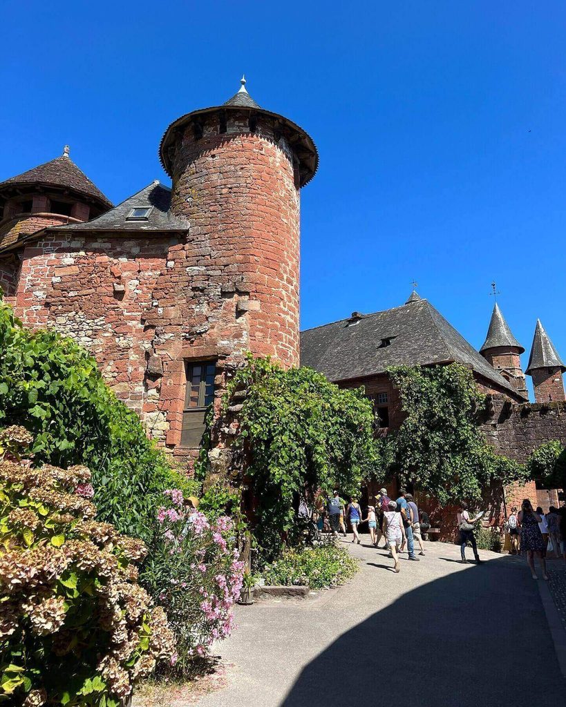Visitors exploring the historic centre of Collonges-la-Rouge