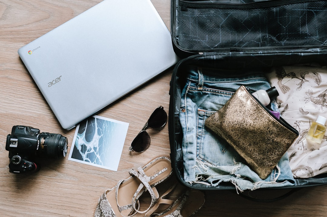Clothes and travel essentials packed into an open suitcase