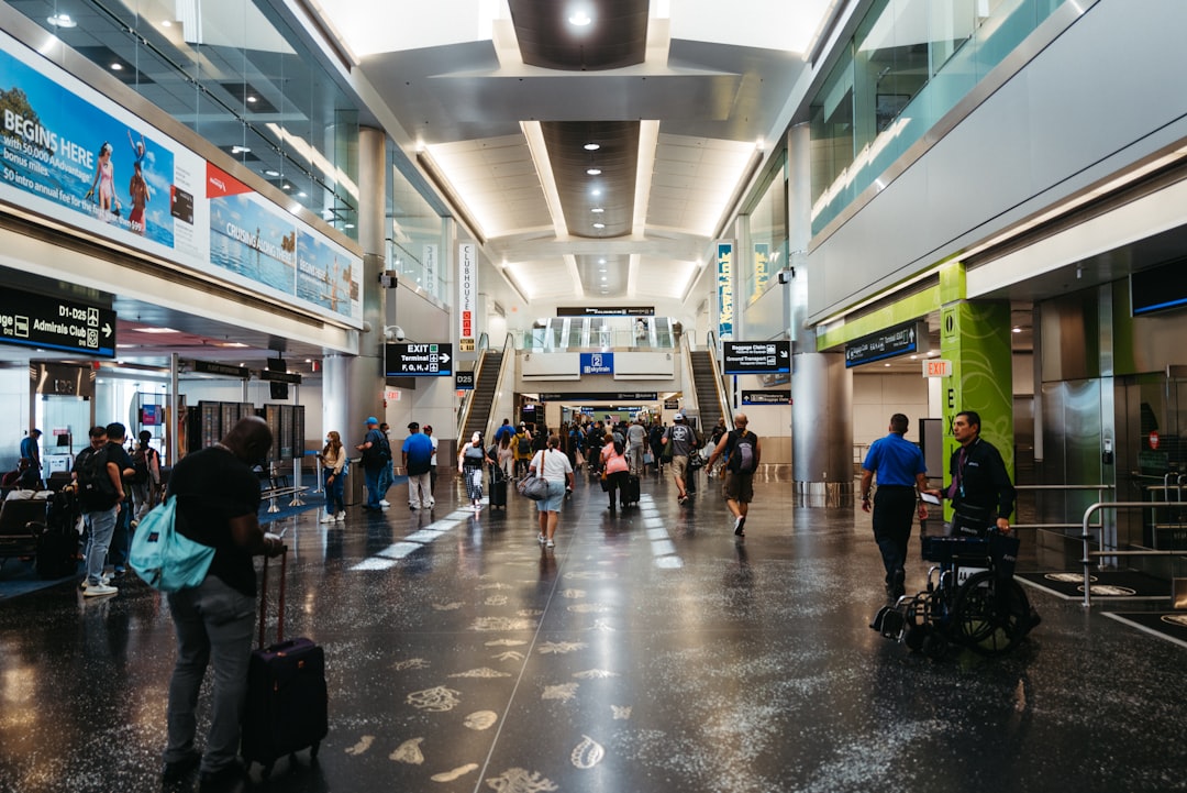 Travelers walking with luggage through an airport terminal