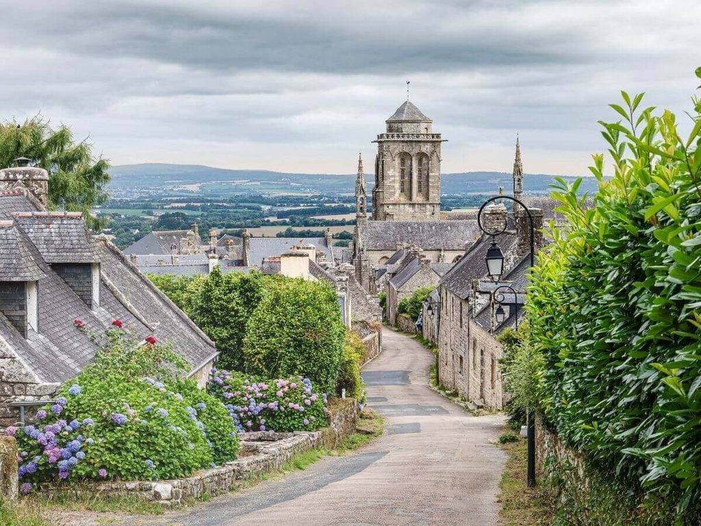 Place de l’Église surrounded by historic granite houses in Locronan, France