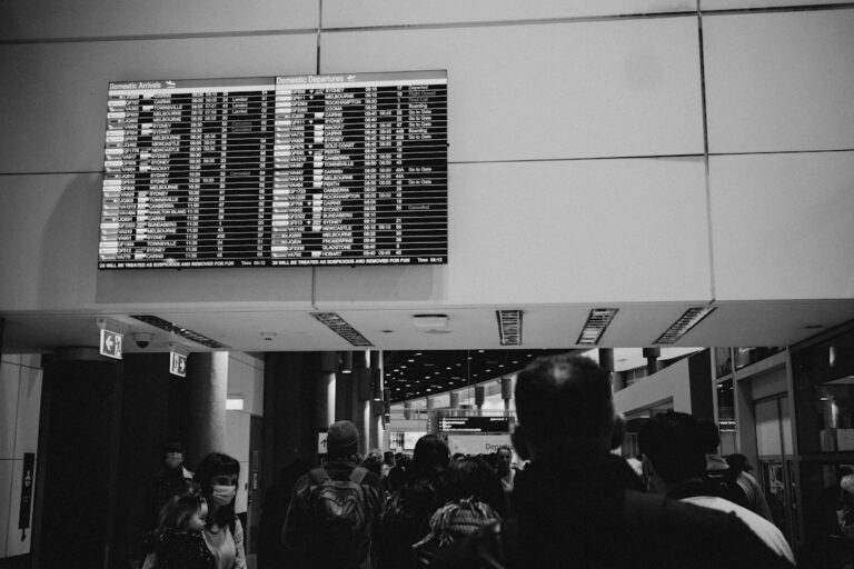 Airport departure board listing flights at a terminal