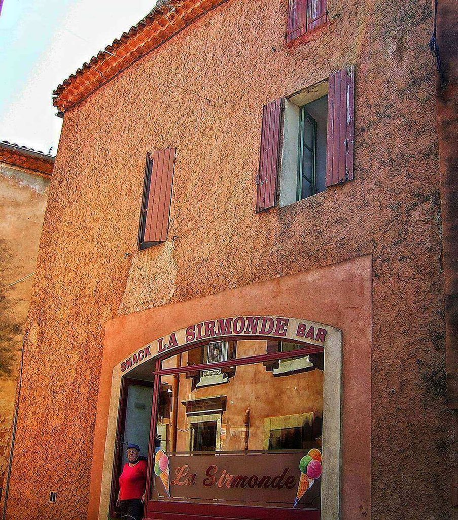 Colourful ochre houses with wooden shutters in Roussillon