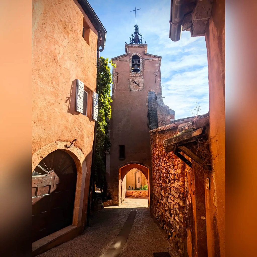 Quiet ochre-coloured street in Roussillon early in the morning