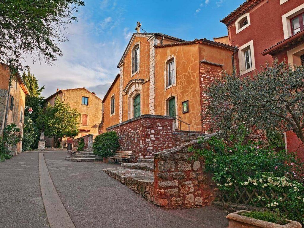 Saint Michel Church viewed from an ochre-coloured street in Roussillon