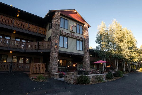 Charming exterior view of Silver Moon Inn in Estes Park, Colorado, featuring cozy lodge-style accommodations, a peaceful riverside setting, and scenic Rocky Mountain surroundings.