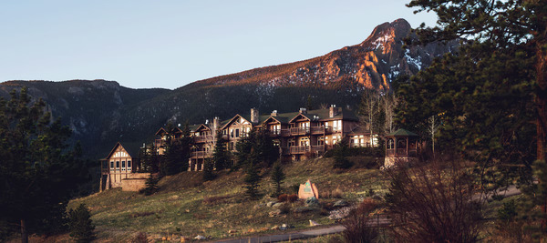 Scenic view of Taharaa Mountain Lodge in Estes Park, Colorado, showcasing its rustic mountain architecture, elegant lodge setting, pine forest surroundings, and panoramic Rocky Mountain views.