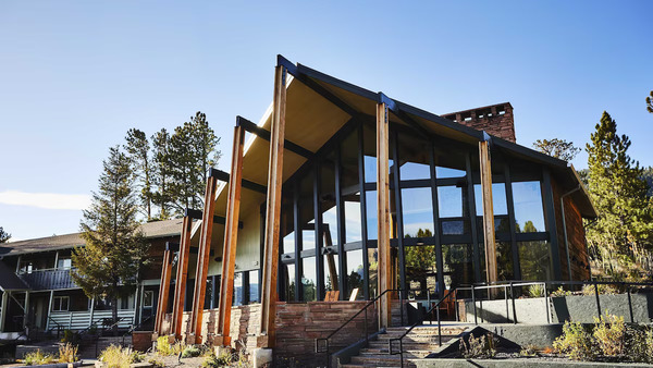 Modern exterior of Trailborn Rocky Mountains in Estes Park, Colorado, featuring contemporary mountain-inspired design, outdoor gathering spaces, and stunning views of the Rocky Mountains.