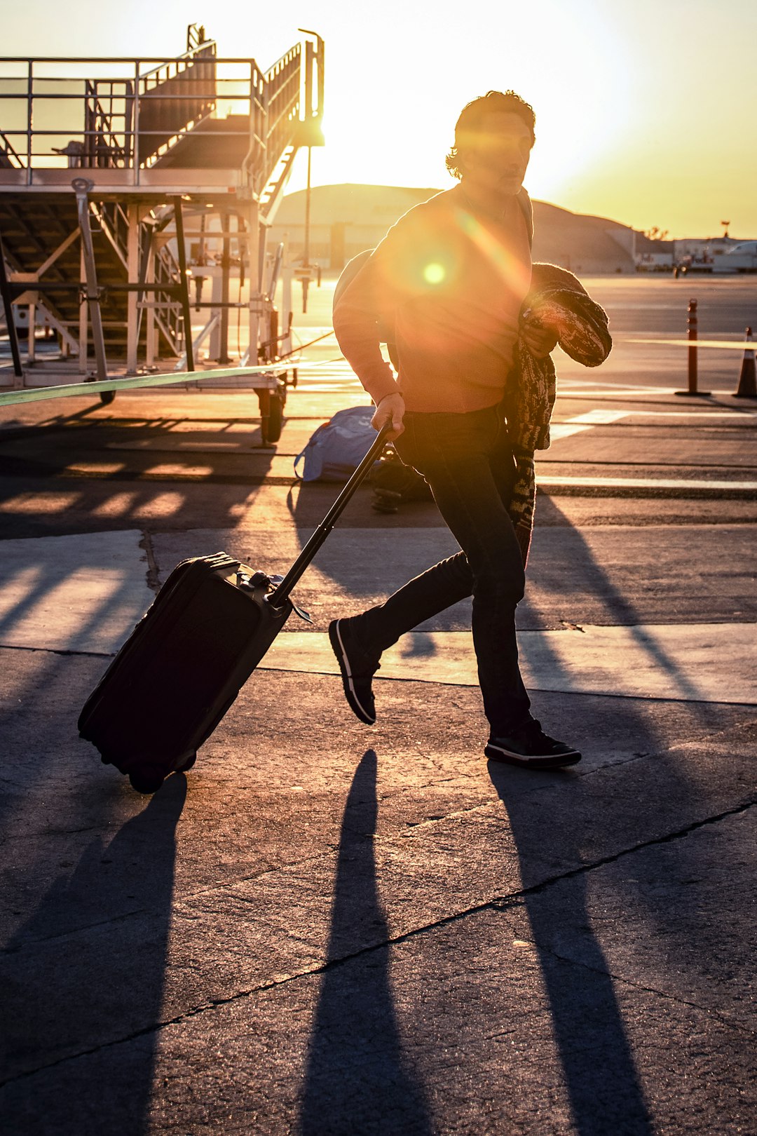 A solo traveler crossing a busy airport terminal with luggage