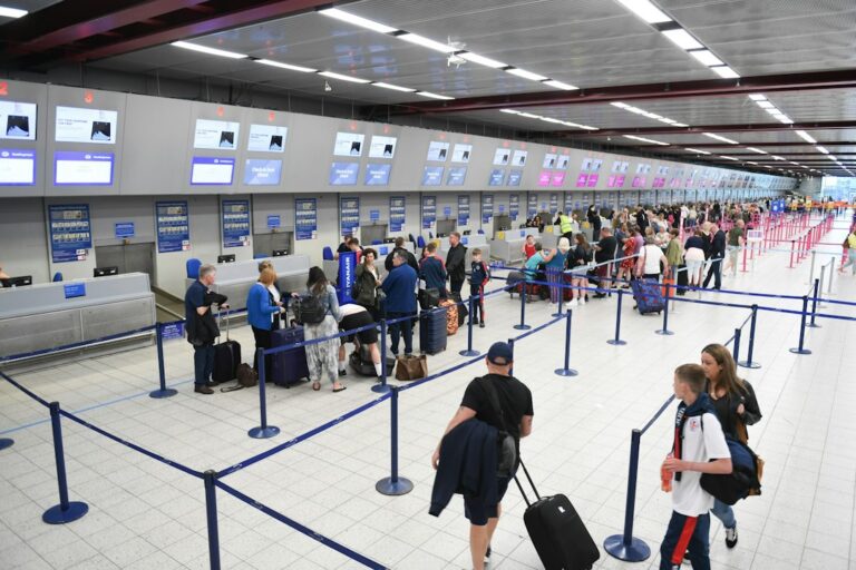 Travelers waiting near an airport passport control area