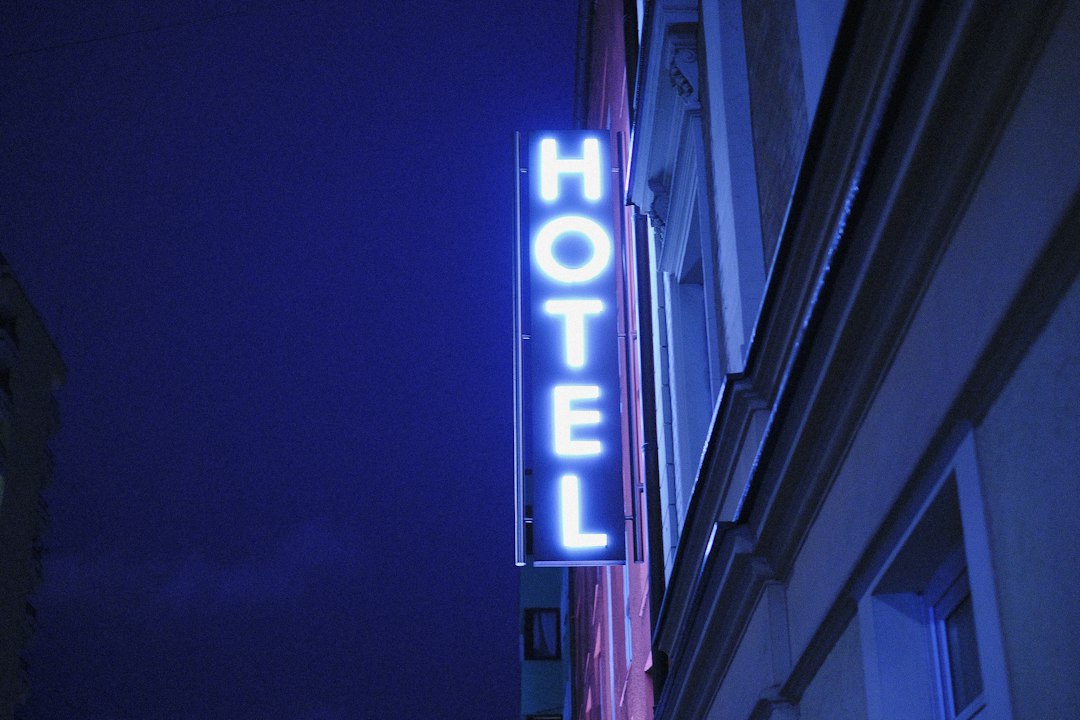 A city hotel building lit up against the night sky