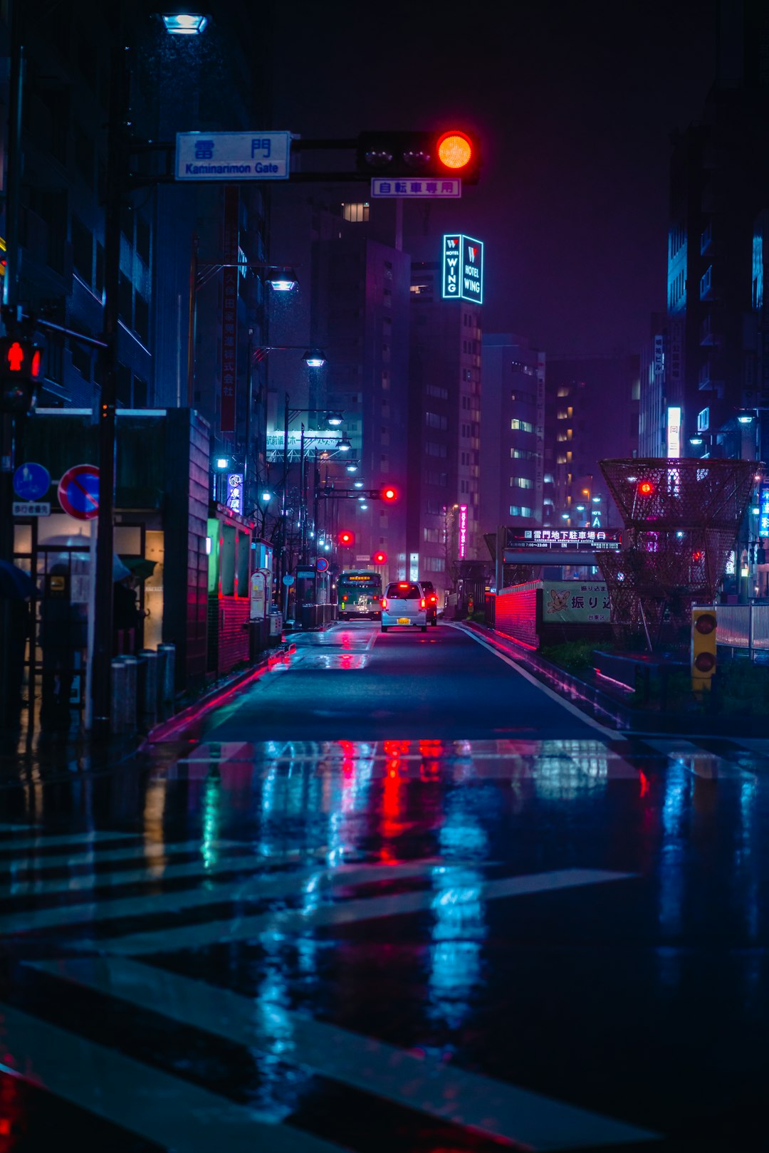 Busy Tokyo street lit with signs at night