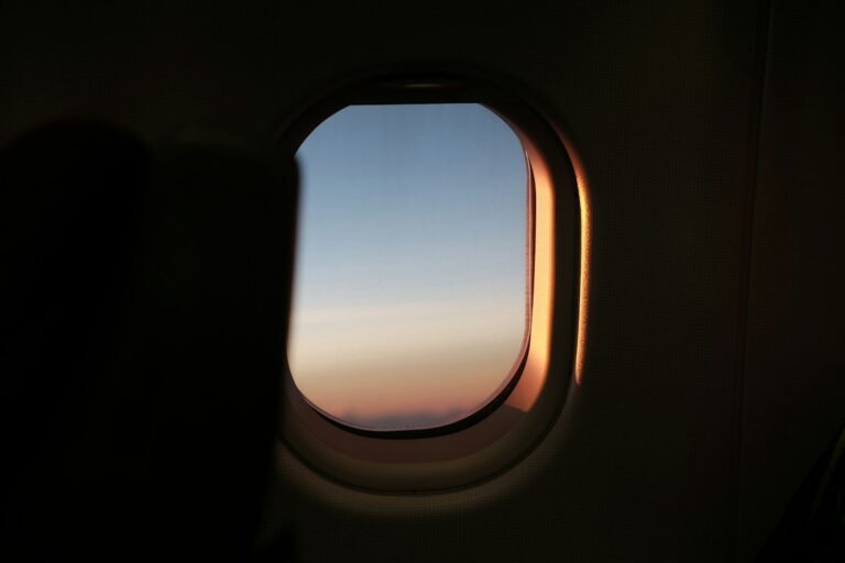 View of a sunrise sky through an airplane cabin window