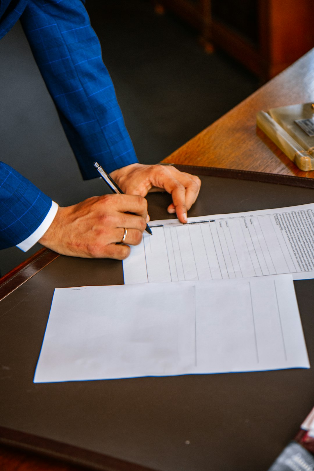 Person writing on white form paper