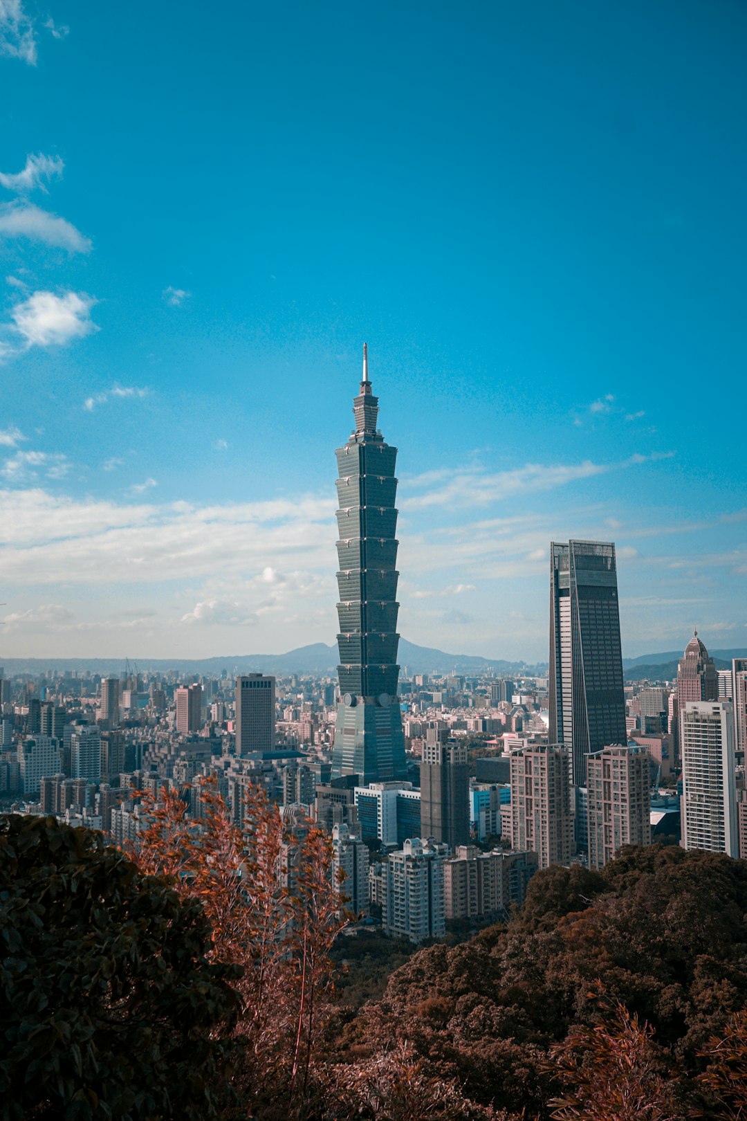 Taipei city skyline with Taipei 101 under a blue sky