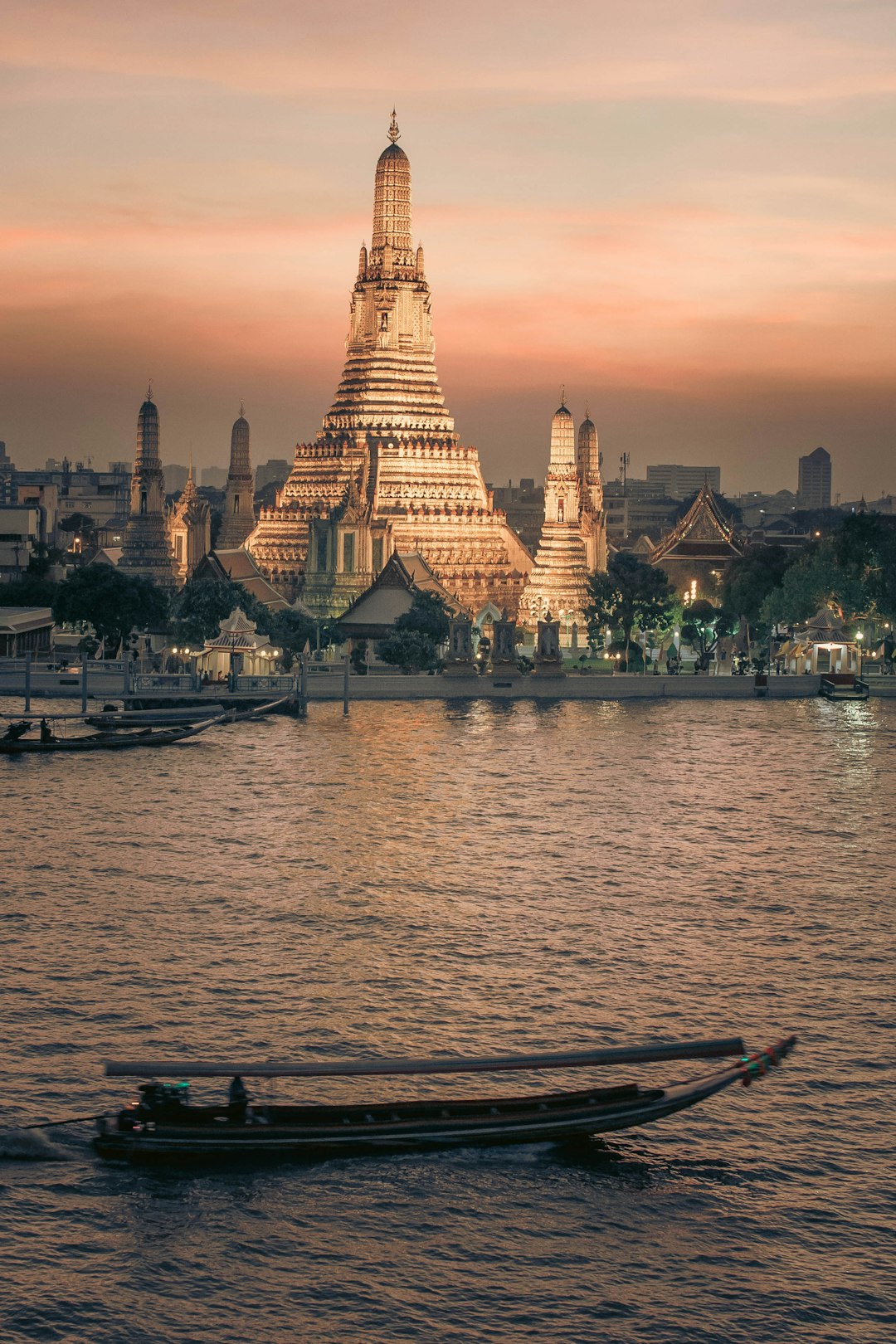A boat on the water in front of a temple in Bangkok, Thailand