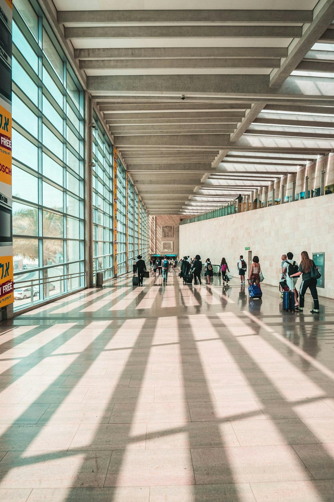 A traveler at an airport terminal window near the departure gates