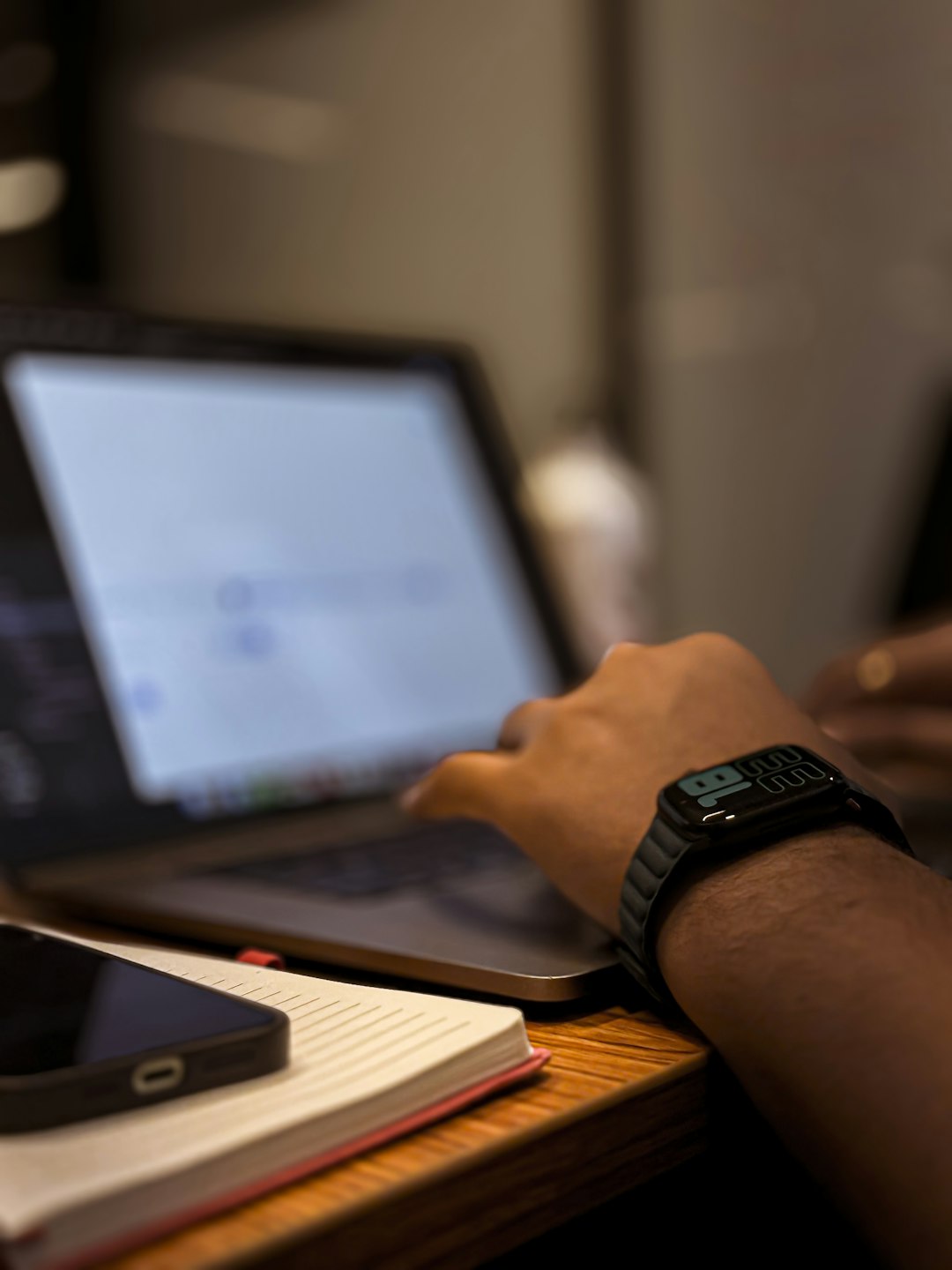 A person filling out an online form on a laptop at a desk