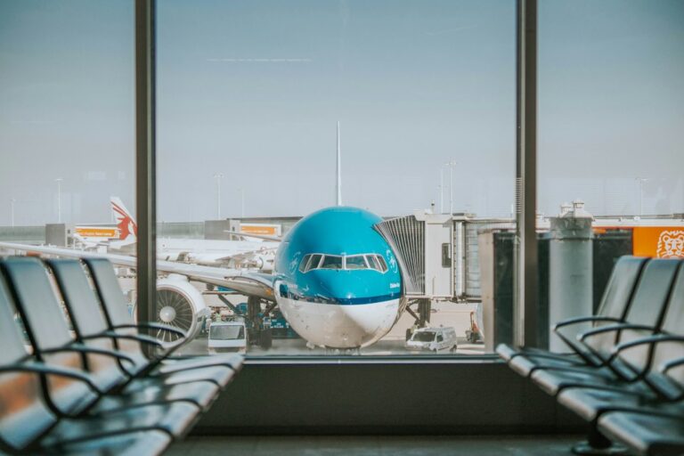 Airplane parked at an airport gate beside a passenger walkway