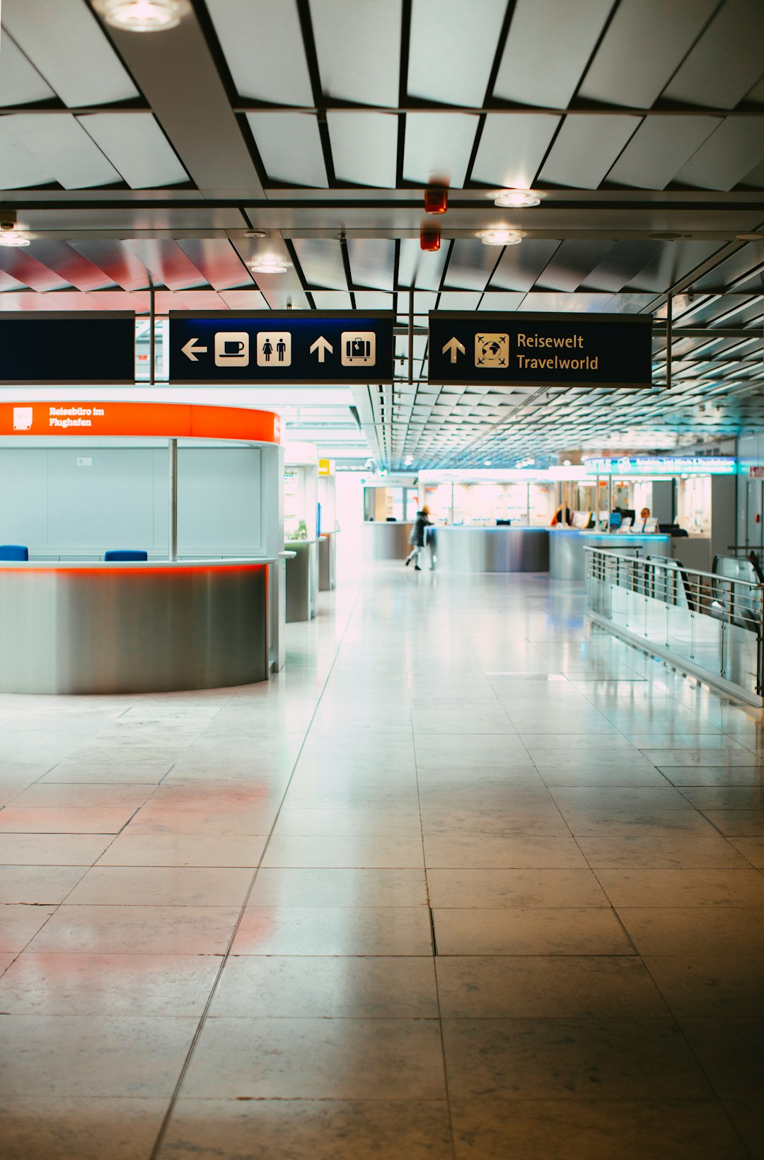 An empty airport gate area with seating near the departure boards