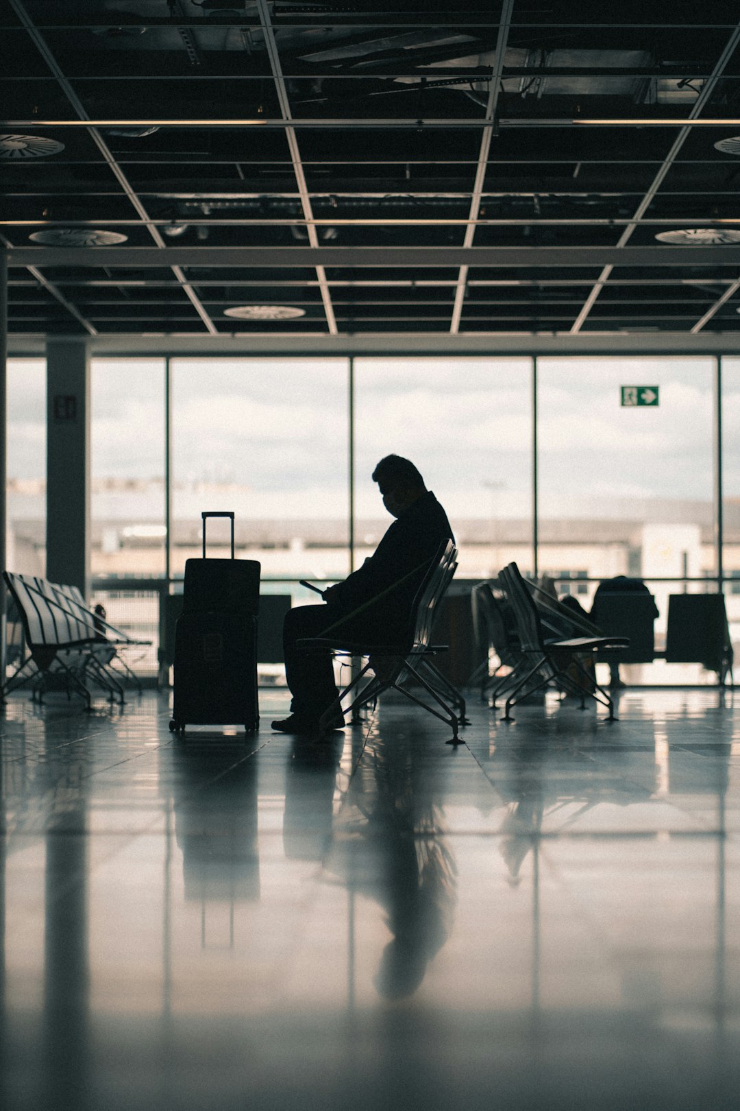 Man in black jacket sitting on chair