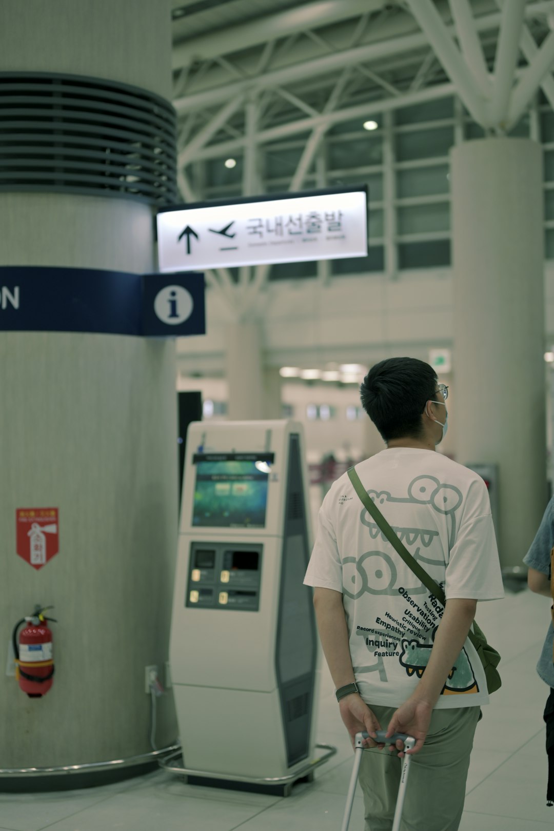 A traveler checking a departure sign at the airport