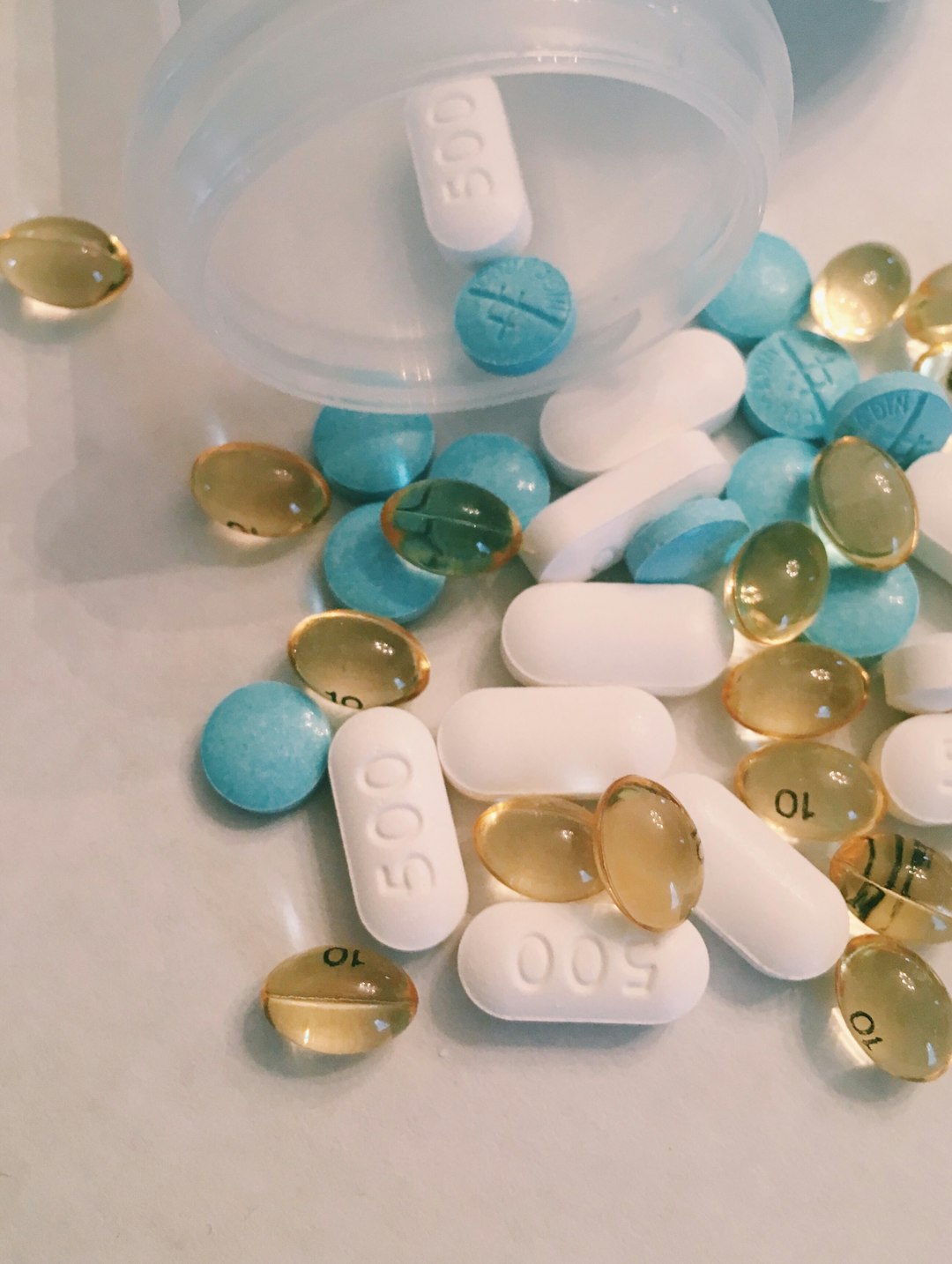 Assorted colorful medication pills spread on a surface