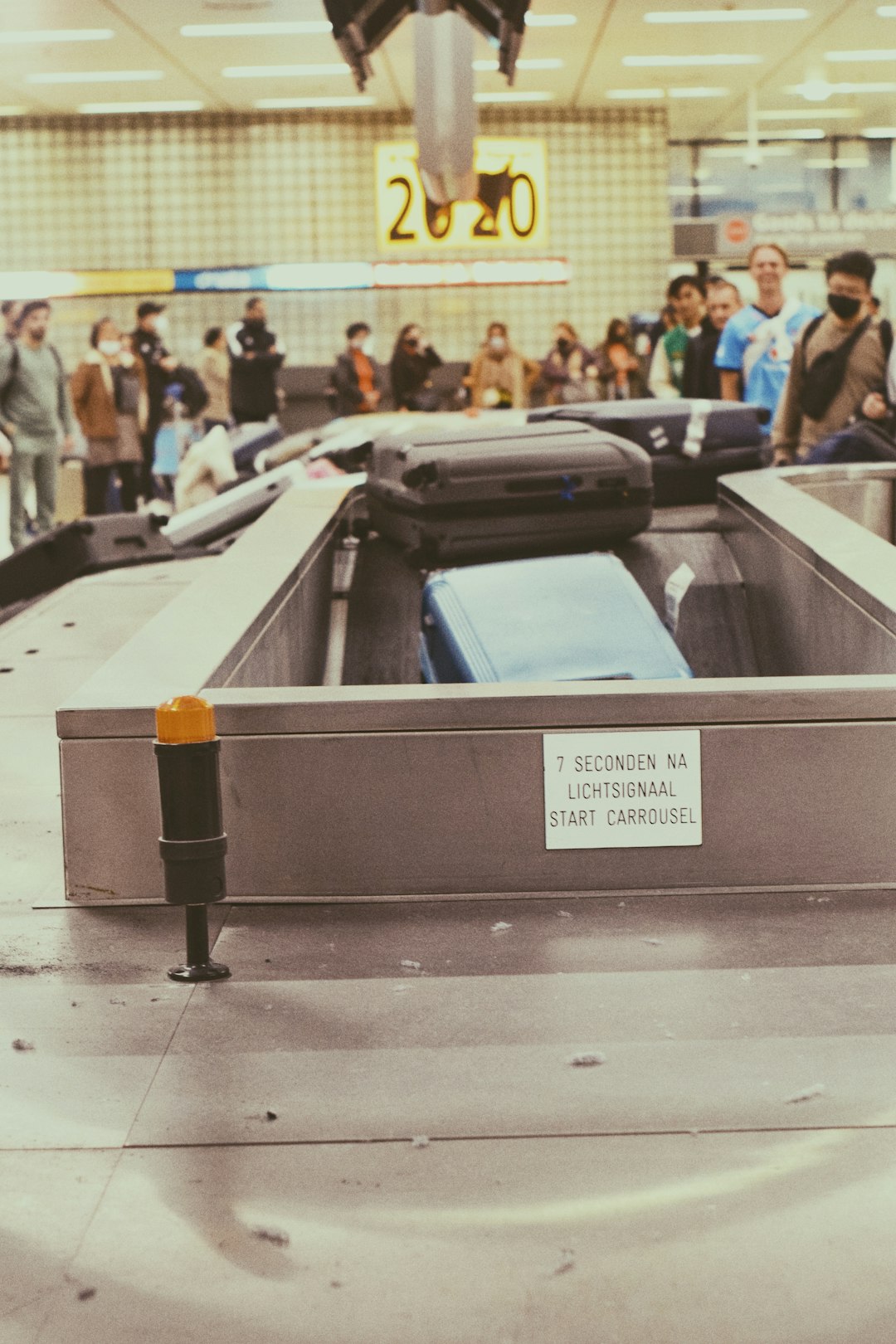Passengers waiting at an airport baggage claim hall
